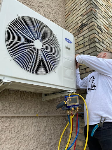 Provincial employee installing air conditioning unit